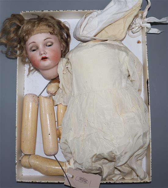 A Simon & Halbig doll, original wig, vintage clothes, head marked 403, missing one lower limb
